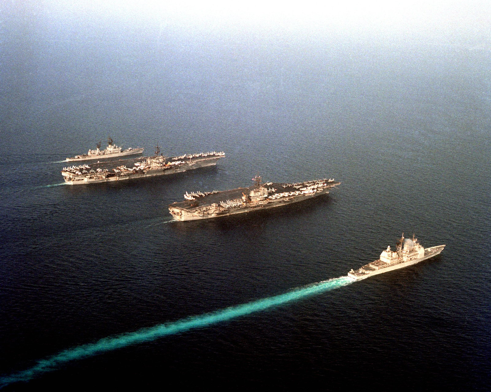 An aerial view of, from upper left, the guided missile cruiser USS ...