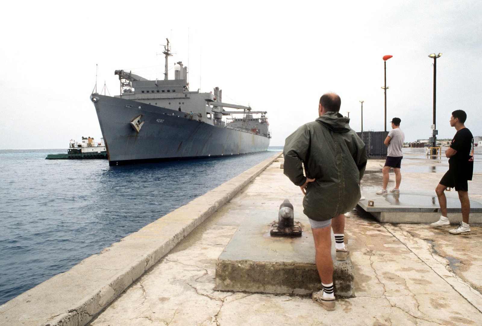 Line handlers stand by as the Military Sealift Command auxiliary crane ...