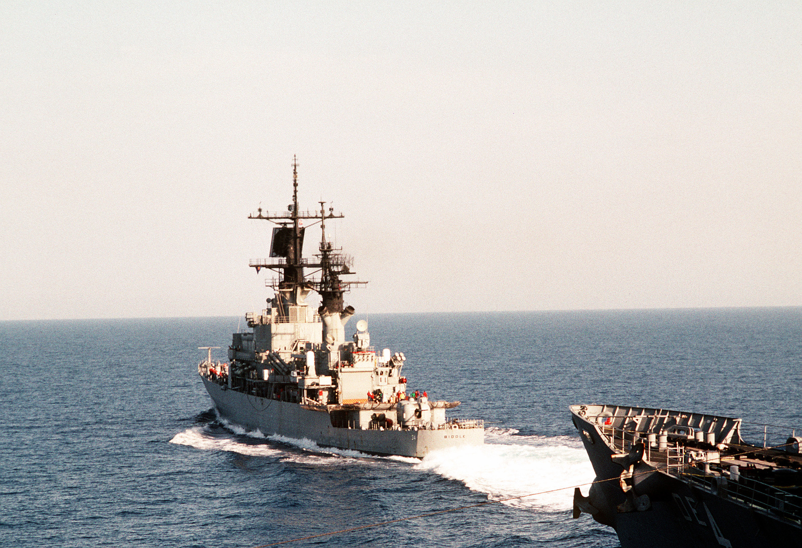 The Guided Missile Cruiser Uss Biddle Cg 34 Passes The Fast Combat Support Ship Uss Detroit