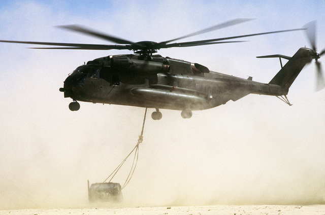 A CH-53E Super Stallion helicopter lowers an M-998 high-mobility ...