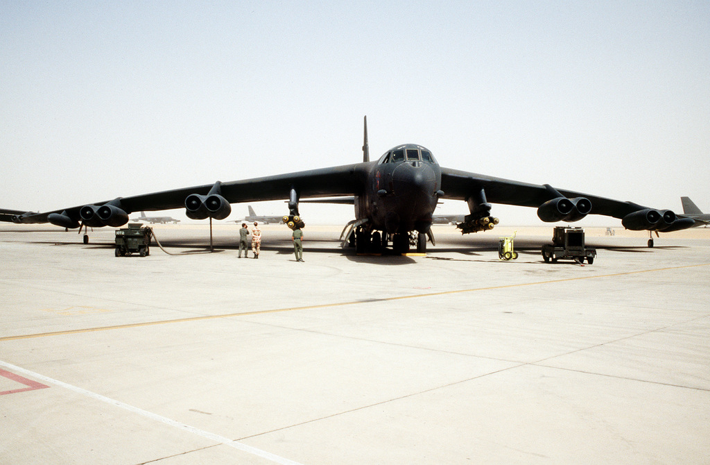 A B-52G Stratofortress aircraft is serviced on the flight line prior to ...