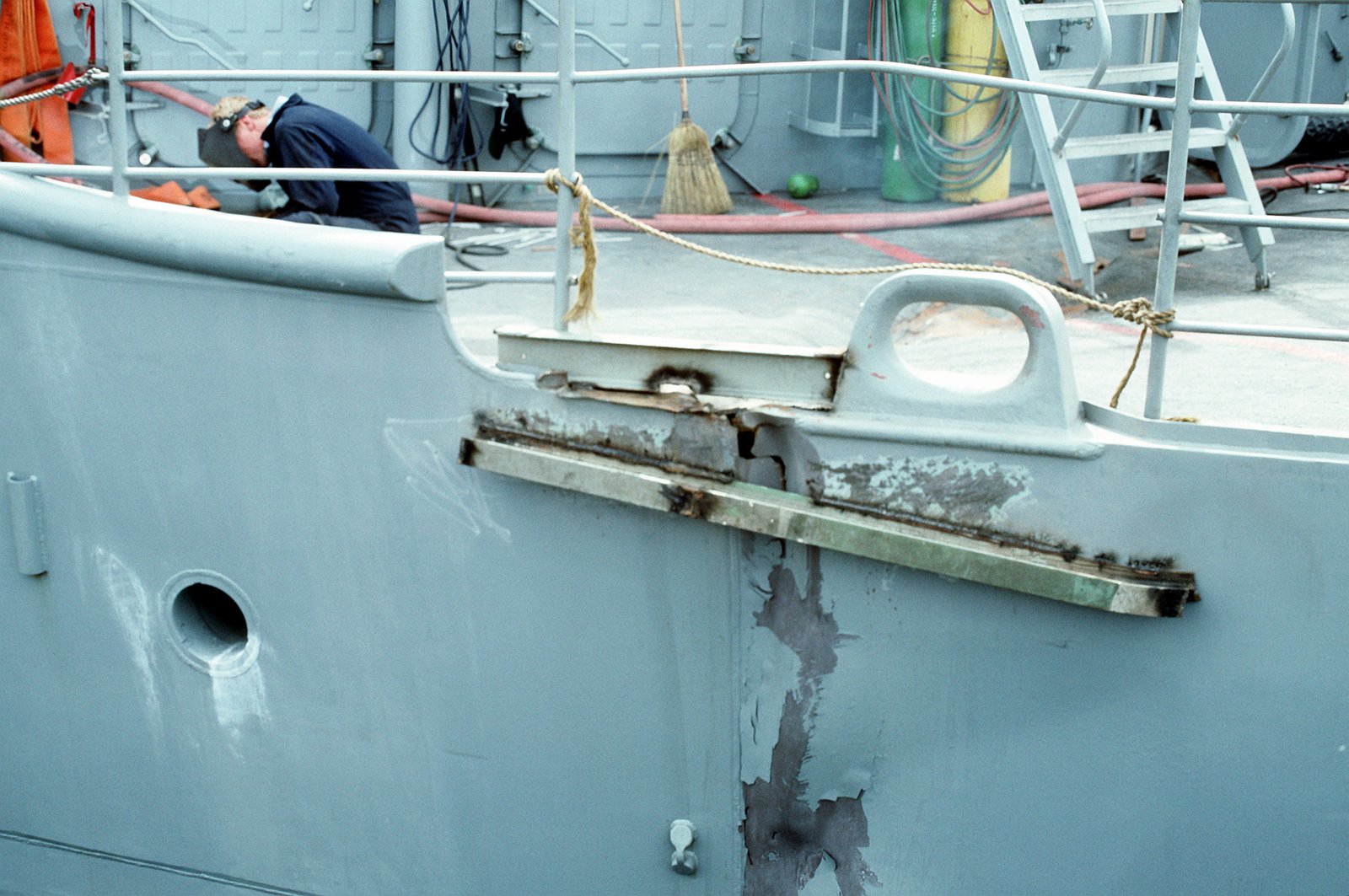 A close-up view of a crack in the hull of the Aegis guided missile ...