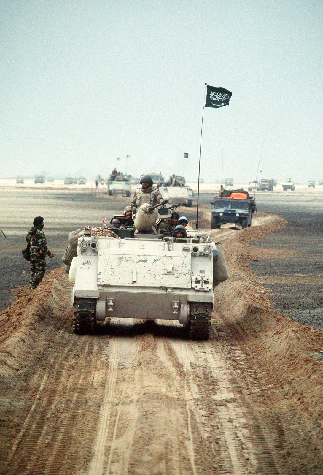 A column of M-113 armored personnel carriers and other military ...