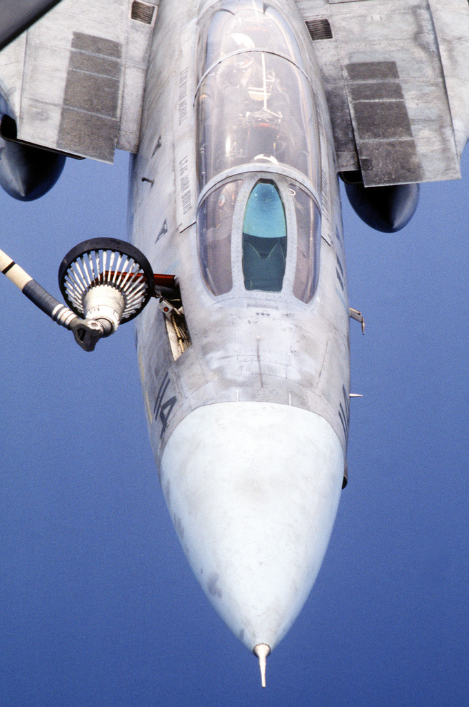 A Fighter Squadron 84 (VF-84) F-14A Tomcat aircraft flies beside an Air  force KC-135E Stratotanker aircraft after an aerial refueling over  southeastern Turkey. The aircraft are operating in support of Operation  Provide