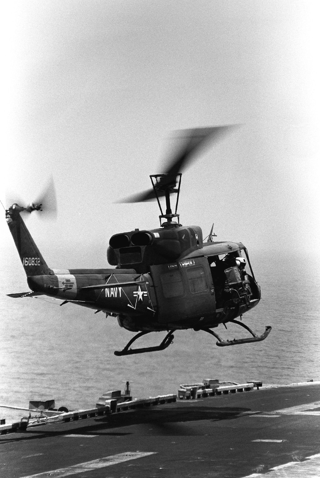 A UH-1N Iroquois helicopter takes off from the flight deck of the ...