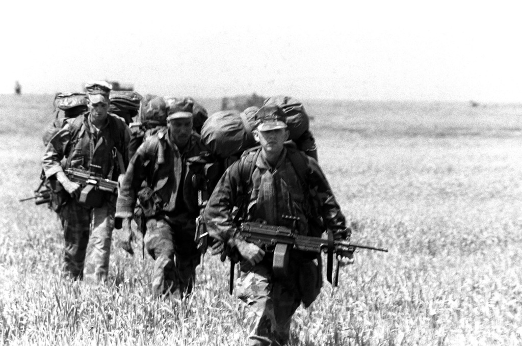 Marines armed with M-249 squad automatic weapons move out on a patrol ...