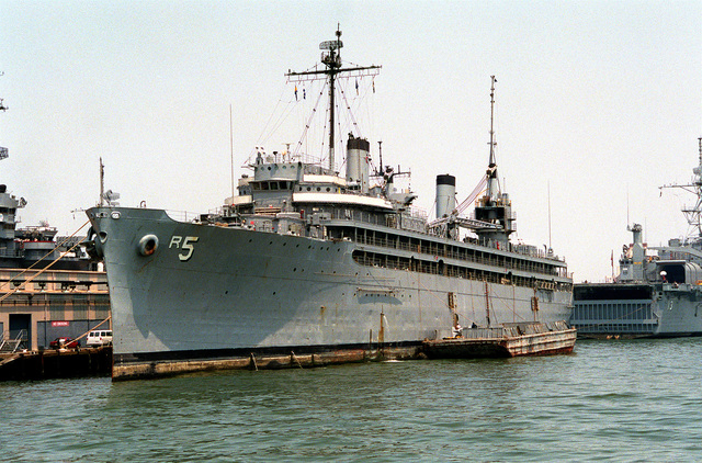 A port bow view of the repair ship USS VULCAN (AR-5) tied up at pier 9 ...