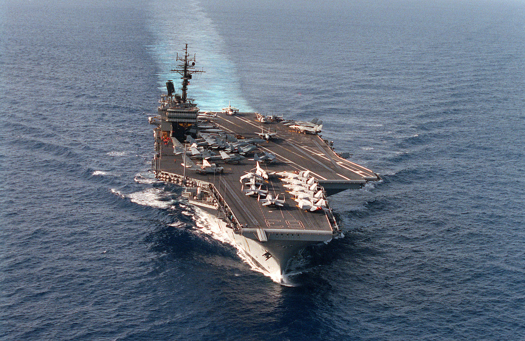 A bow view of the aircraft carrier USS KITTY HAWK (CV-63) underway off ...