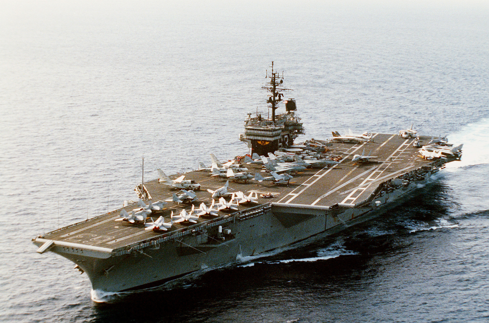 A port bow view of the nuclear-powered aircraft carrier USS KITTY HAWK ...