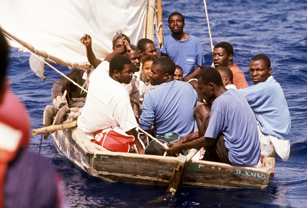 Haitian Refugees Watch From Their Crowded Sailboat As A U.S. Coast ...