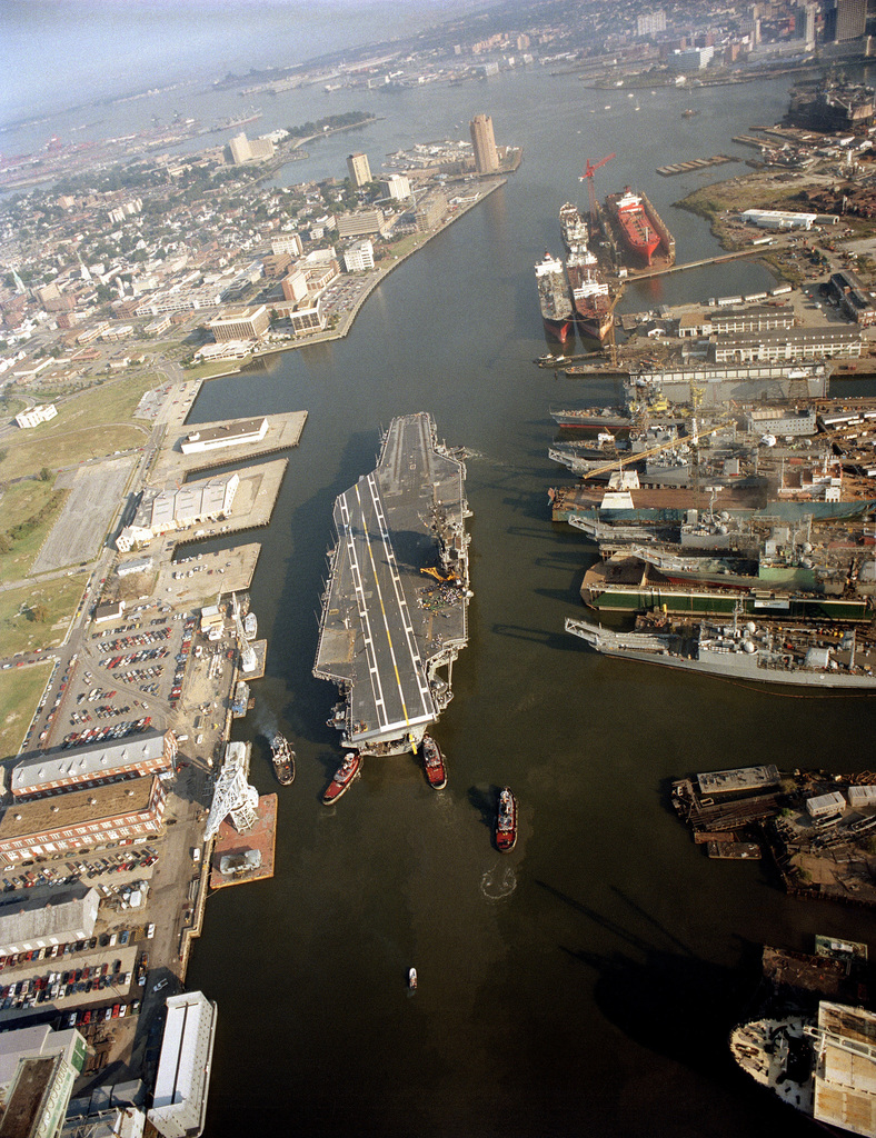 Harbor tugs maneuver the aircraft carrier USS JOHN F. KENNEDY (CV 67 ...