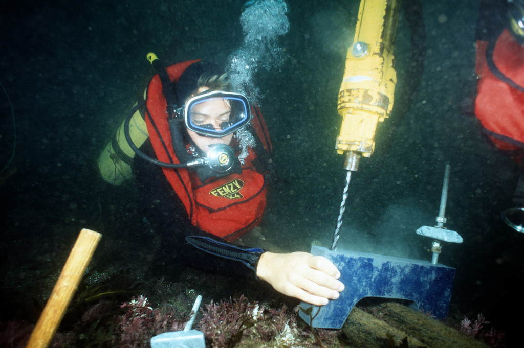 Two Divers Of Underwater Construction Team 2 (UCT-2) Use An Underwater ...