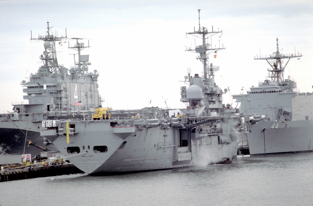 The Amphibious Assault Ships Uss Nassau Lha 4 Left And Uss Iwo Jima Lph 2 Lie Tied Up Near