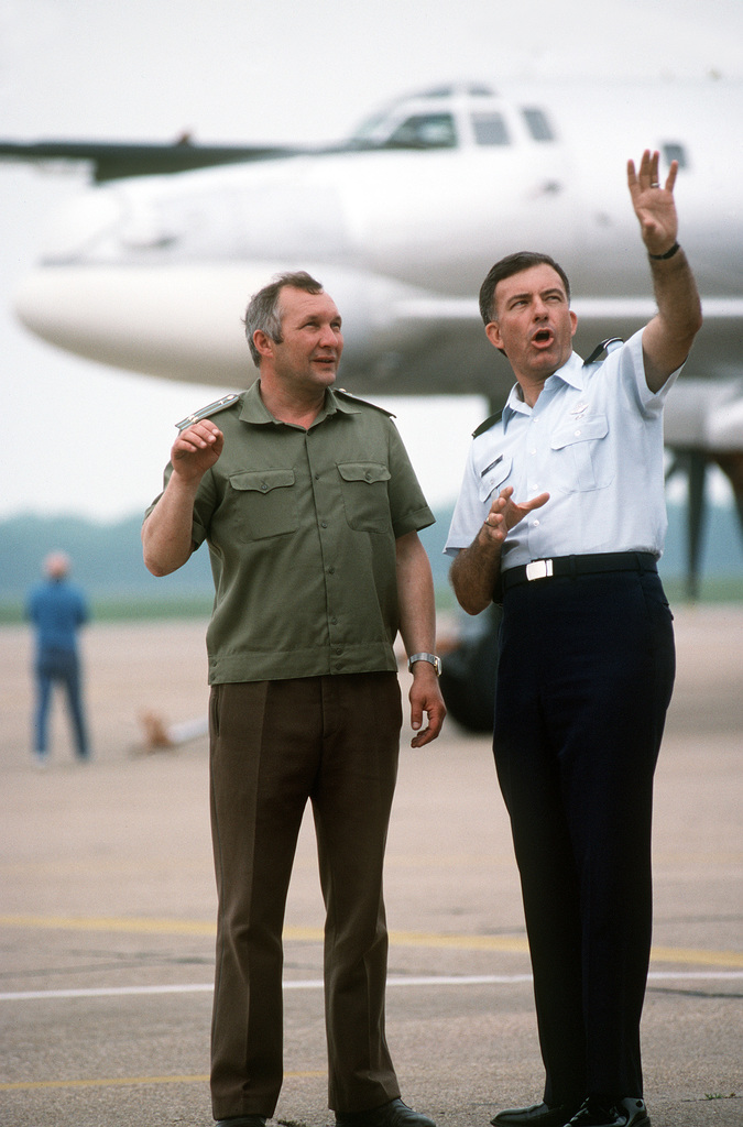 Two Tu-95 Bear bomber aircraft, center, and an AN-124 Condor transport  aircraft of the Russian military, background, are parked on the flight line  beside a B-52H Stratofortress aircraft of the 62nd Bombardment