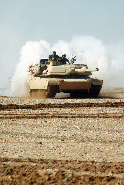 An M-1A1 Abrams main battle tank lays a smoke screen during maneuvers ...