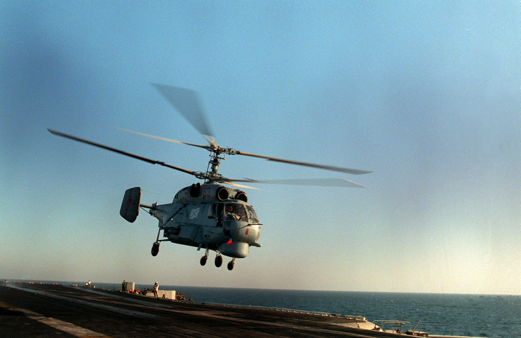 A Russian Ka-27 Helix helicopter takes off from the flight deck of the ...