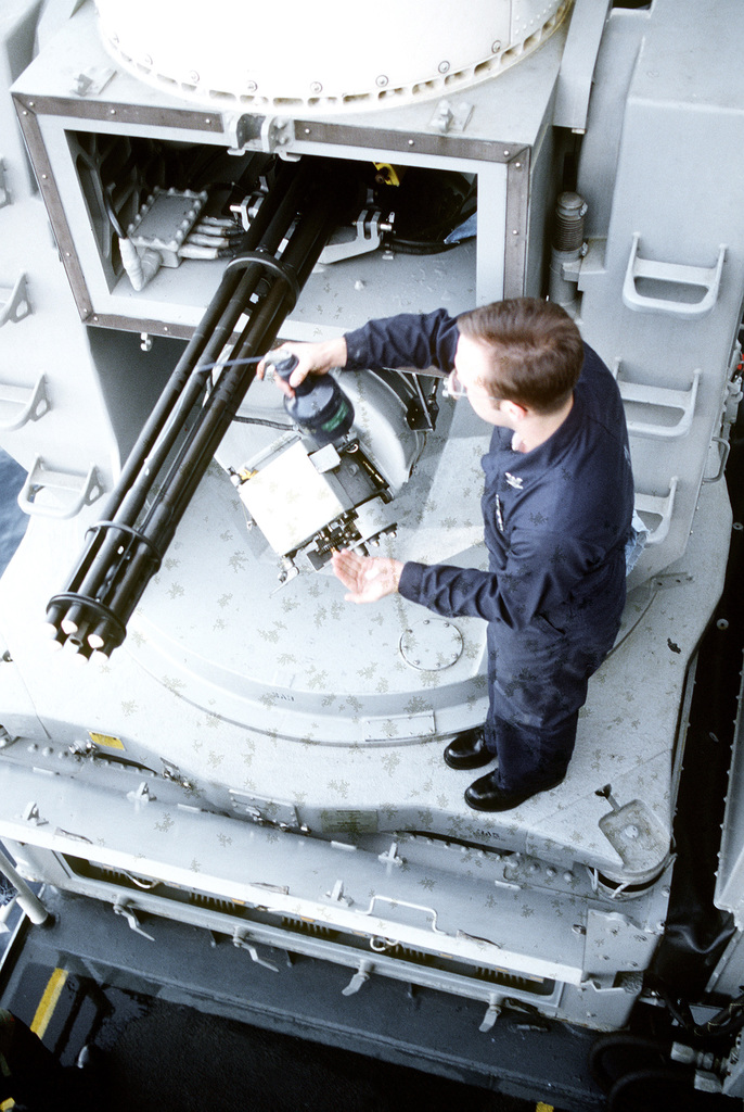 A fire control technician performs preventive maintenance on one of the ...