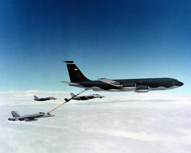 A Strike Fighter Squadron 147 (VFA-147) F/A-18C Hornet aircraft refuels ...