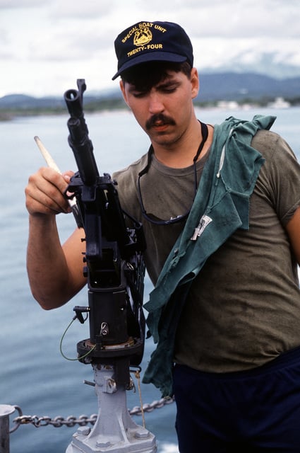 US Navy Engineman 2nd Class Anthony Bartelli (right) holds an