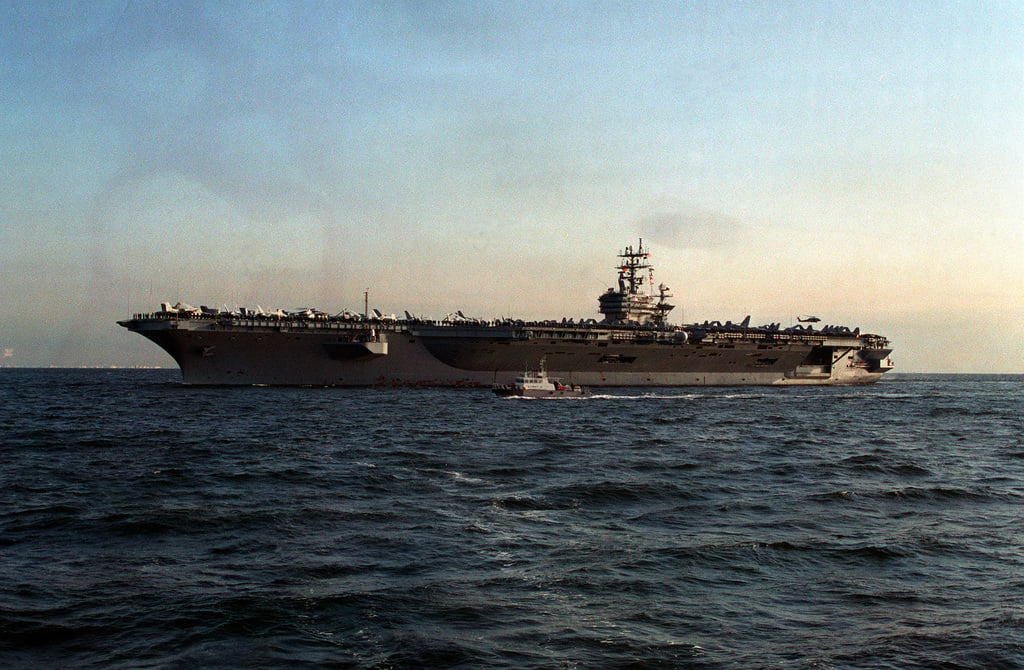 A port side view of the nuclear-powered aircraft carrier USS CARL ...