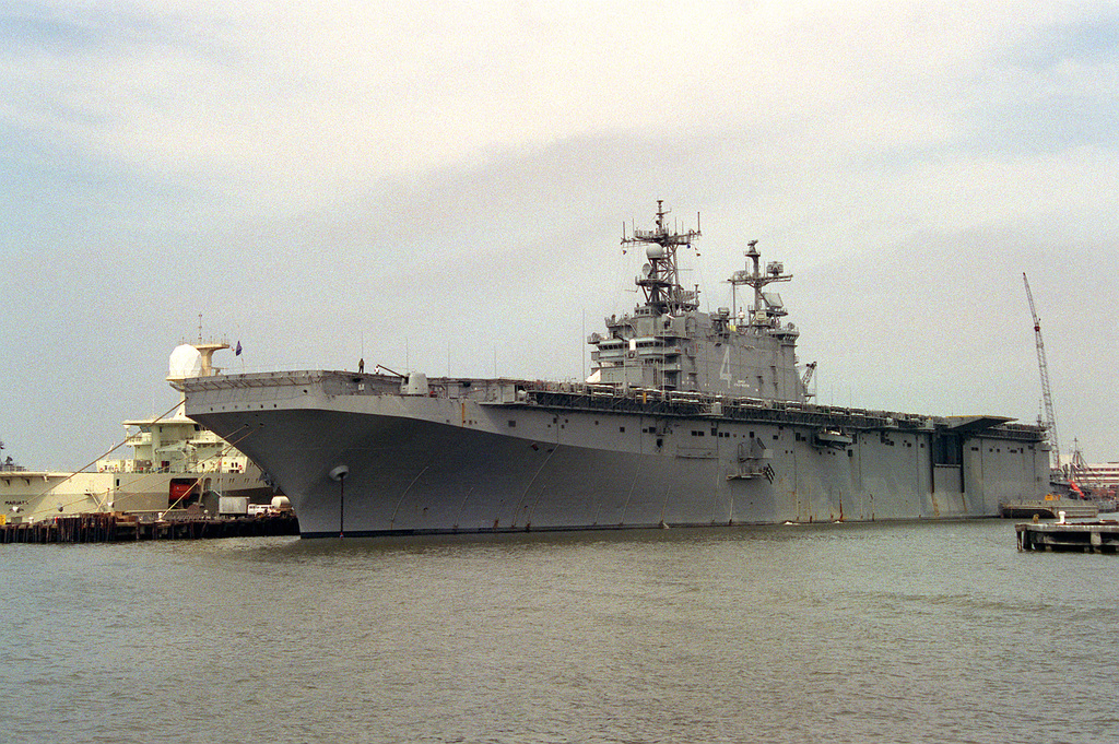 A port bow view of the amphibious assault ship USS NASSAU (LHA-4) tied ...