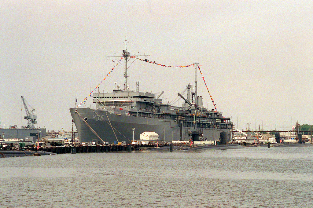 A port bow view of the submarine tender USS L. Y. SPEAR (AS-36) tied up ...