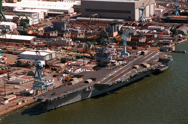 An aerial port bow view of the nuclear-powered aircraft carrier USS ...