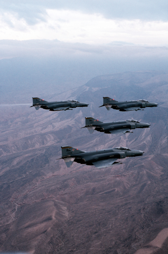 An aerial right side view of a four ship formation of USAF F-4G Phantom ...