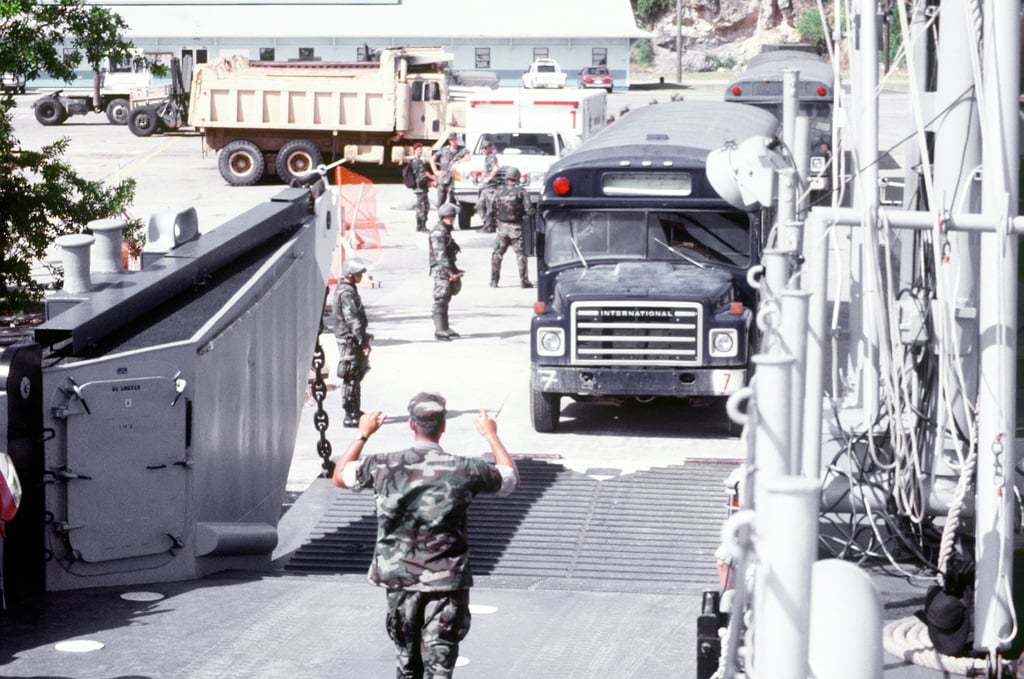 A US Air Force bus carrying Cuban immigrants drives onto a US Navy ...