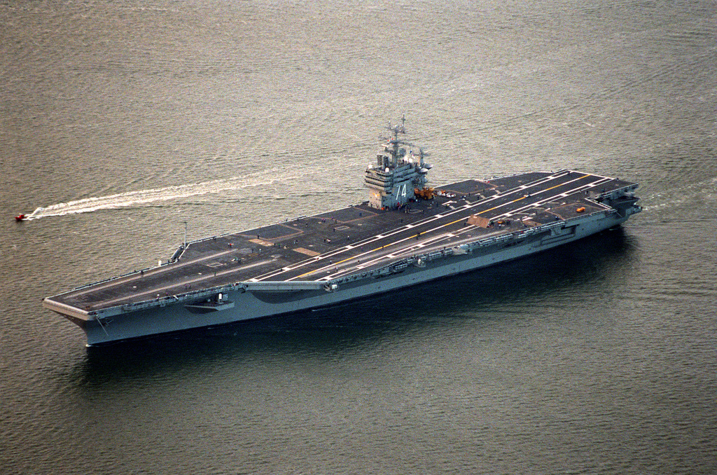 An aerial port bow view of the nuclear-powered aircraft carrier USS ...