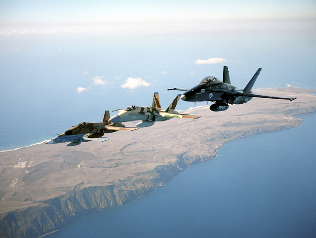 A four ship of F/A-18 Hornet from the TOPGUN school fly in echelon ...