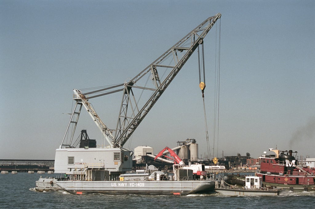 The service craft floating crane YD 186 is shown being moved from