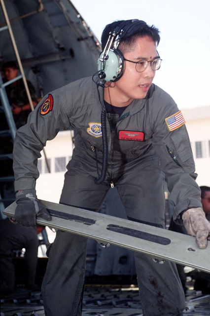 US Air Force STAFF Sergeant Roland Reves from the 21st Airlift Squadron ...