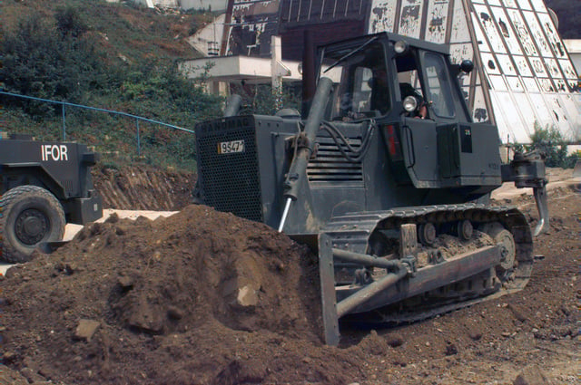 A Bull Dozer Earth Moving Machine Operated By A Belgian Engineer Works On A Parking Area