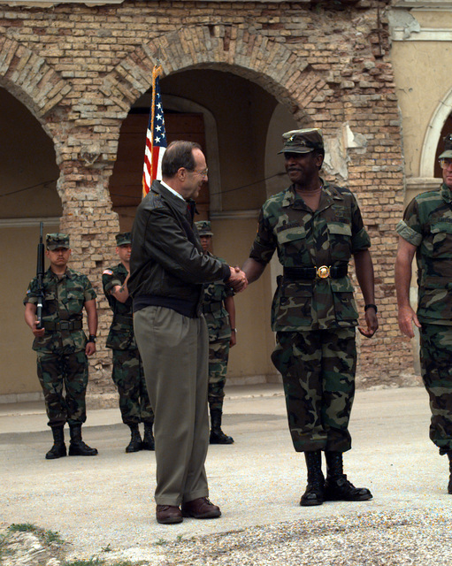 The Secretary of Defense, the Honorable William J. Perry, congratulates ...