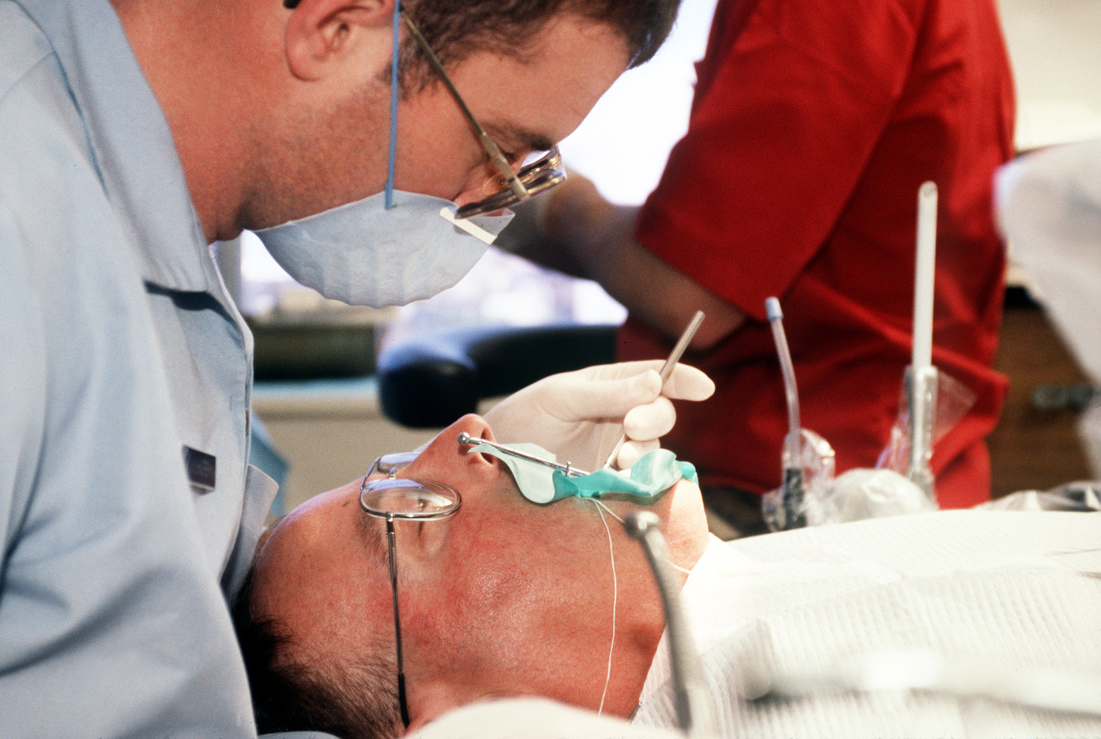 61st Medical Squadron Dentist, Dr. Johnson, fills a cavity for STAFF ...