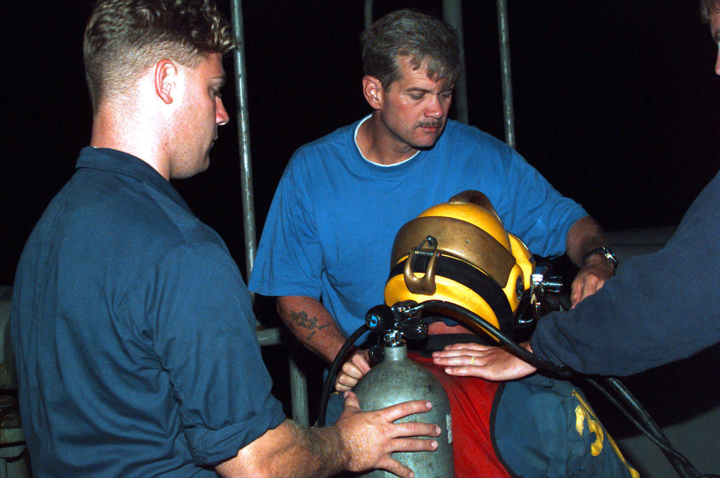 US Navy Engineman 2nd Class Anthony Bartelli (right) holds an