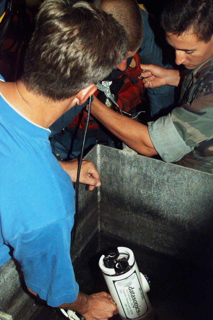 US Navy Engineman 2nd Class Anthony Bartelli (right) holds an