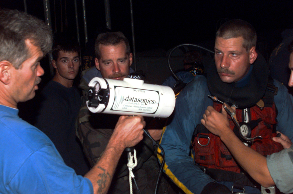 US Navy Engineman 2nd Class Anthony Bartelli (right) holds an