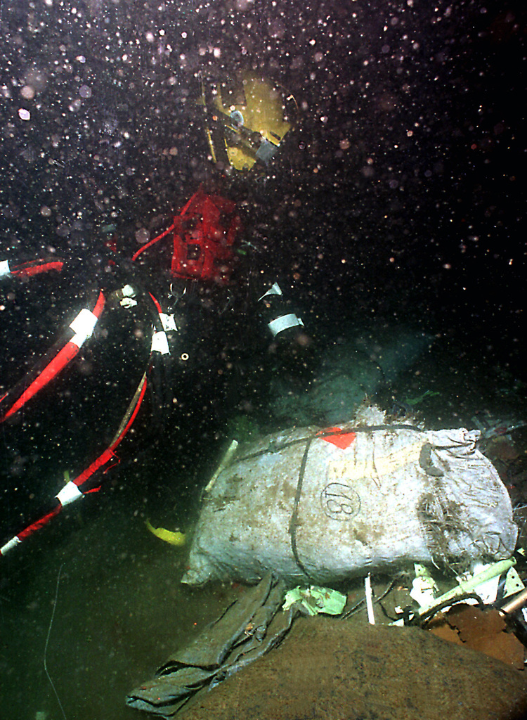 Diver walks on the bottom amid TWA Flight 800 debris