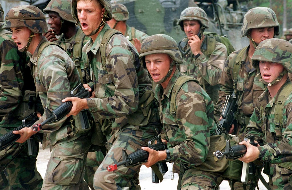 US Marines armed with M16A2 rifles demonstrate what a front line should ...