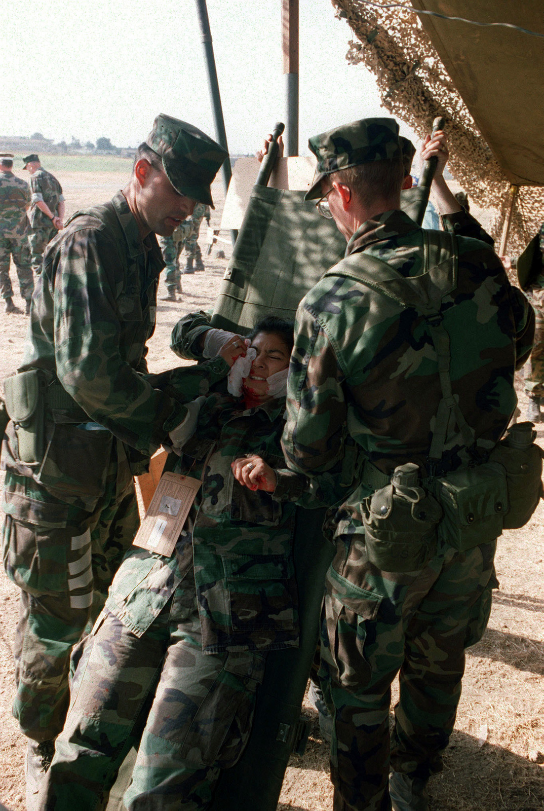 A simulated casualty of war victim is brought into the Field Hospital ...