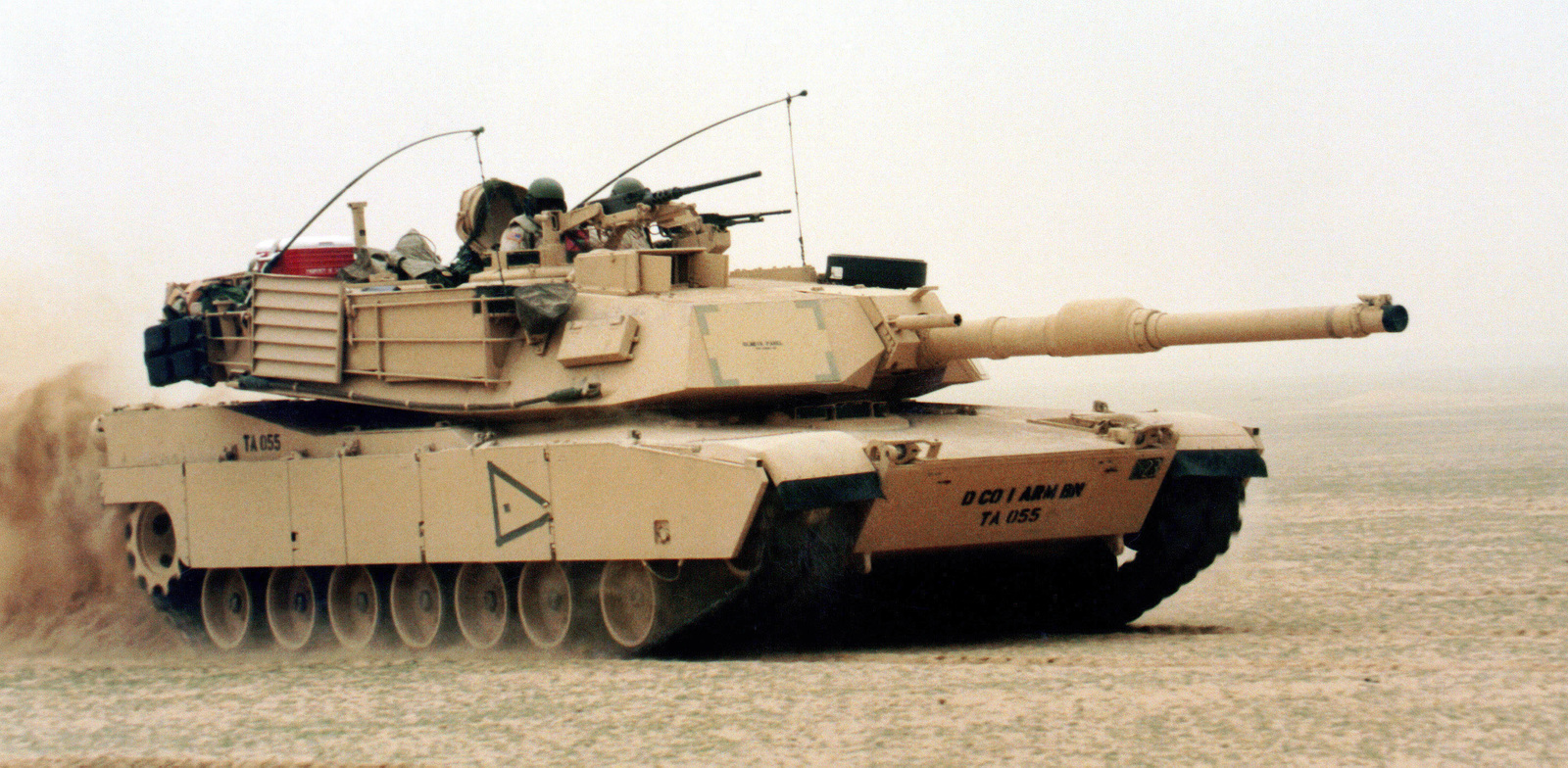 A U.S. tank team, in an M1A1 Abrams Main Battle Tank (MBT), advances ...