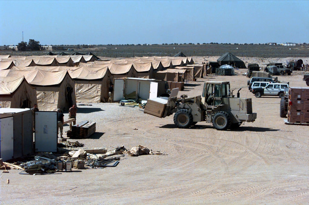 An All-Terrain Forklift positions a load of plywoood in front of a row ...