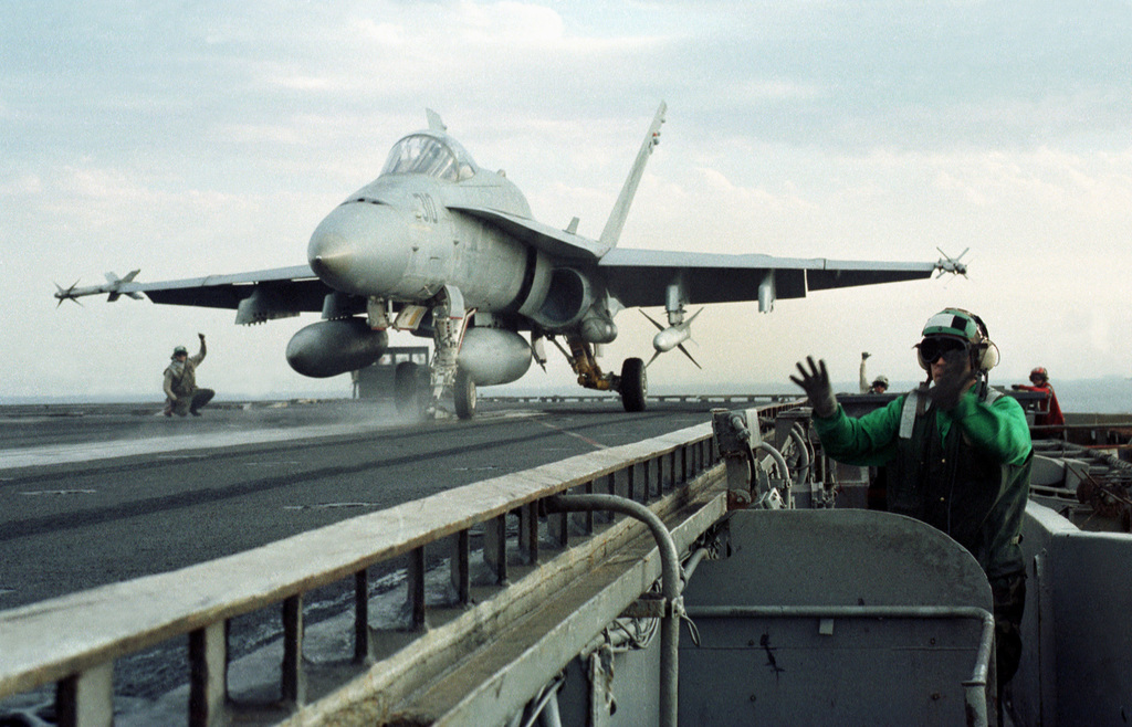 ABE3 Joshua Schwandt makes final launch signals for a F/A-18 Hornet ...