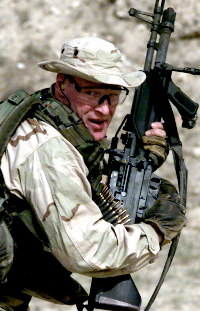 A US Navy SEAL, from SEAL Team 8, manuevers with a M-60 machine