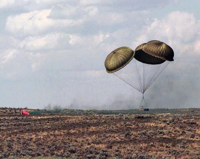 A heavy load of palletized cargo lands near the designated heavy drop ...