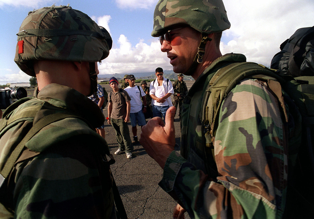 CWO3 Dough McKenzie (right), attached to the 13th Marine Expeditionary Unit,  Camp Pendleton, California, Command Element makes last minute preparation  before the Non-combatant Evacuation Operation (NEO) during exercise RIMPAC  98 - PICRYL 