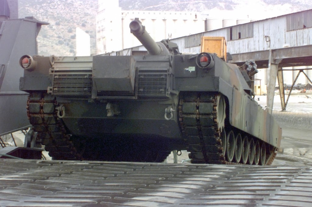 An Abrams M1A1 Main Battle Tank (MBT) is backloaded onto the Maritime ...