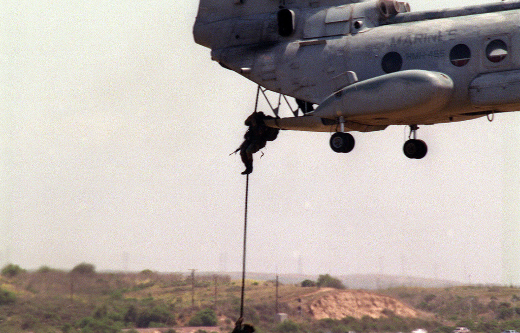 U.S. Marines fast-rope from a CH-46E Sea Knight helicopter onto